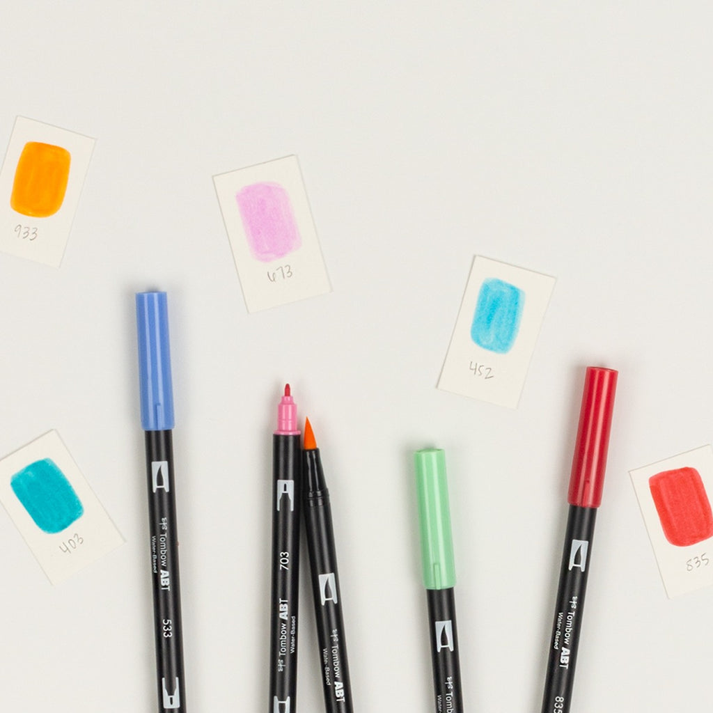 Set of markers with color swatches on a light gray background